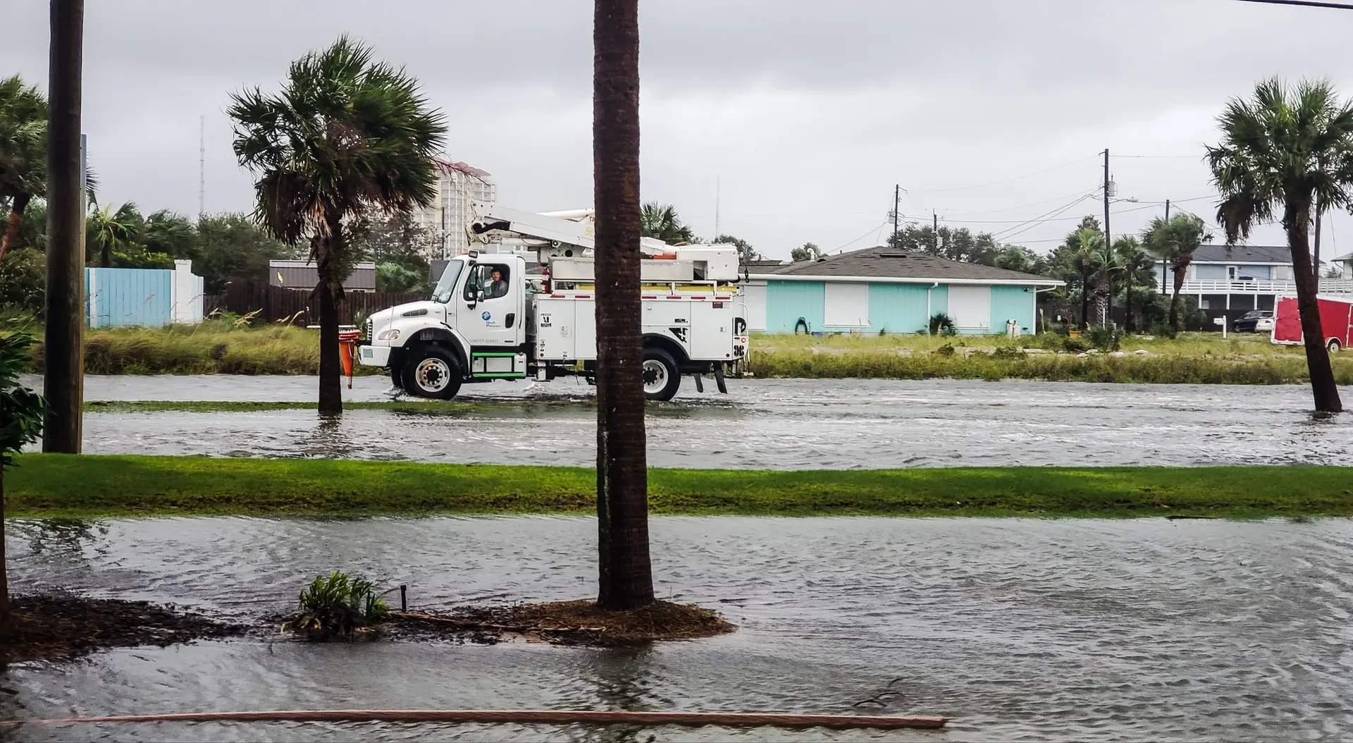 Transportation and logistics after hurricane damage on water logged roads at the beach community.